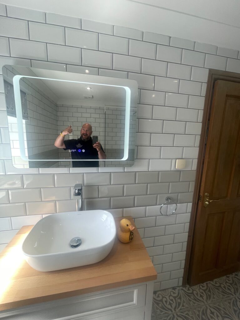 A fabulous new mirror with backlight in this en-suite project from Dymchurch Improvements.