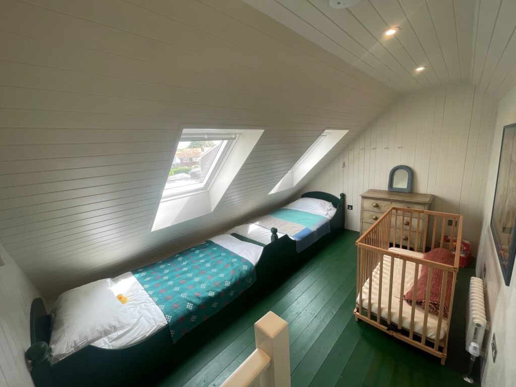 A renovated loft space which was turned into a bedroom by Dymchurch Improvements.
