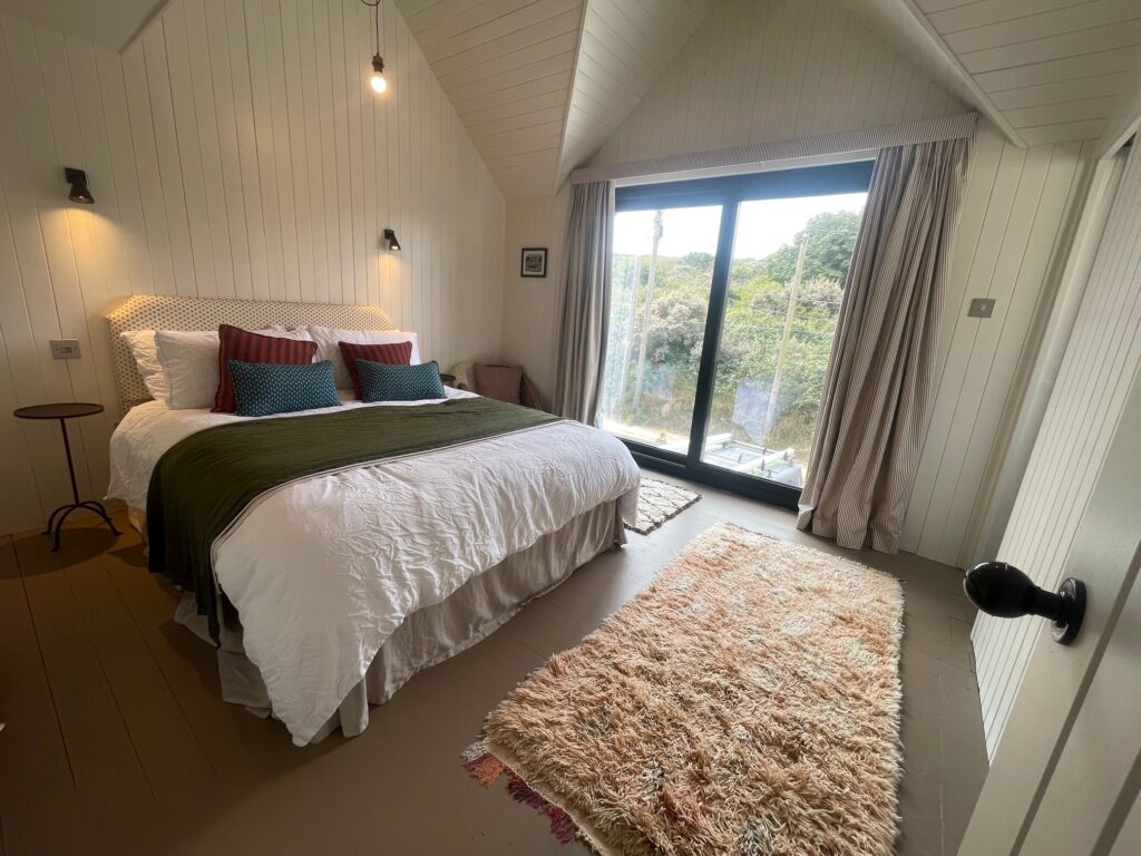 A master bedroom with sliding doors renovated by Dymchurch Improvements.